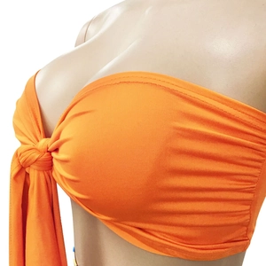 Close-up of orange strapless tube top featuring ribbed knit fabric and front knot detail