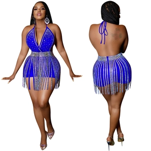 Detail of sapphire blue backless halter set featuring rhinestone fringe and deep V-neck