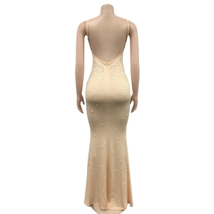 Detailed back view of backless bodycon maxi dress with rhinestones and pearls