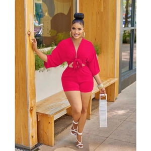 Detail of rose red two-piece set featuring V-neck tie-front top and high waist shorts
