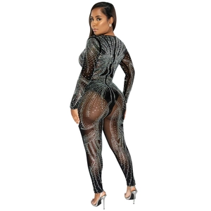 Detail of sheer black mesh bodysuit with geometric rhinestones and long sleeves for parties