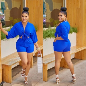Electric blue two-piece set featuring lace-up crop top and high-waisted skinny shorts