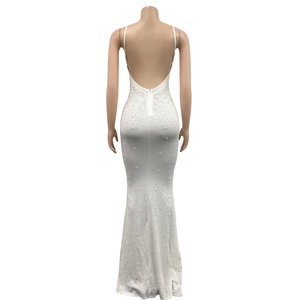 Detail of white backless dress with pearls and rhinestones on high-stretch fabric