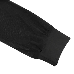 Detail of sheer black mesh sleeve with elastic ribbed knit cuff on a 3-piece clubwear outfit