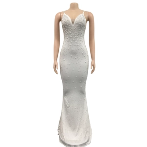 Close-up of white mermaid dress featuring elegant faux pearl embellishments and a deep V-neckline