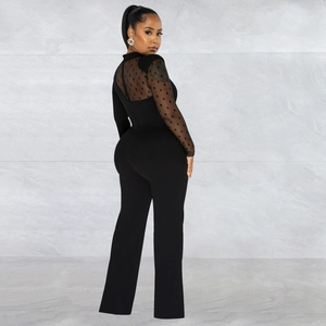 Close-up of the back detail on black mesh polka dot jumpsuit with sheer long sleeves