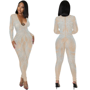 Detail of sheer nude mesh bodysuit featuring intricate rhinestone wave patterns and V-neck