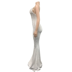 Detailed close-up of gradient silver rhinestones on a white fishtail evening dress