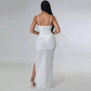 Detailed back view of white sheer mesh dress with silver rhinestones and high slit
