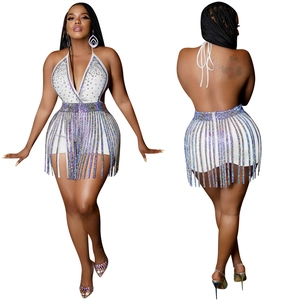 Detail of sequined fringe skirt and rhinestone halter top on a sparkling party set