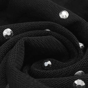 Macro shot of black sheer mesh fabric with sparkling silver rhinestones for clubwear