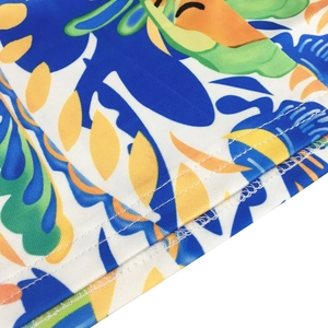 Detail shot of tropical print pants featuring precise double-needle stitching and twill fabric