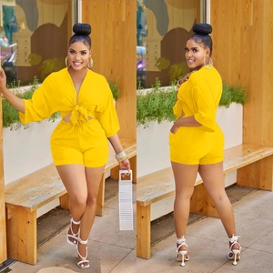 Close-up of vibrant yellow two-piece summer set with V-neck bow top and high-waist shorts
