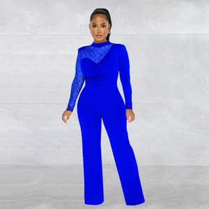Detail of royal blue jumpsuit showing polka dot mesh patchwork and long sleeves