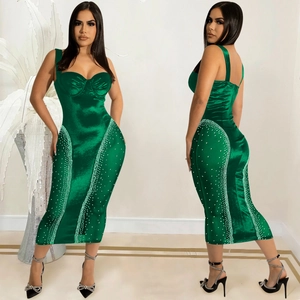 Detail of emerald green satin midi dress with side rhinestone accents and sweetheart neck
