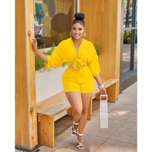Detail of a bright yellow summer set with a tie-front V-neck top and high-waist shorts