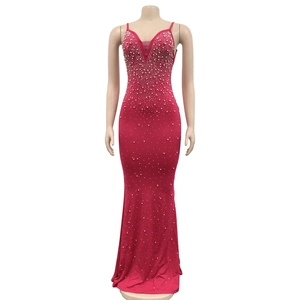 Detail of hot-fix rhinestones on a sexy fuchsia long dress with spaghetti straps