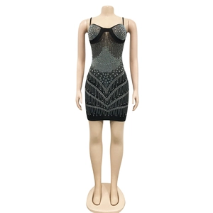 Close-up of sparkling silver rhinestones and mesh patchwork on black bodycon dress