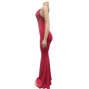Detail of red rhinestone studded floor-length fishtail dress with elegant spaghetti straps