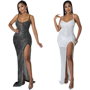 Detail of sheer mesh dress featuring wavy rhinestones, thin straps and high side slit