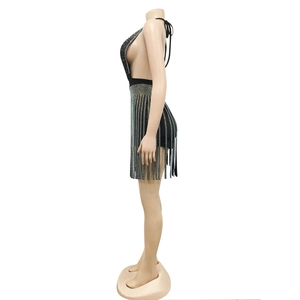 Detailed side view of black backless halter dress featuring sparkling silver rhinestone tassels