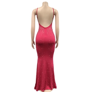 Close-up of pink rhinestone mermaid evening dress showing the deep U-shaped back design