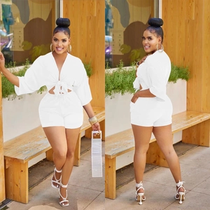 Detail of white two-piece summer set with V-neck tie-front top and slim shorts