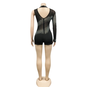 Détail d'un body en mesh noir à une manche avec des strass argentés brillants au dos
