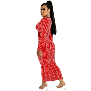 Detail of red bodycon maxi dress with shimmering rhinestone web pattern and long sleeves