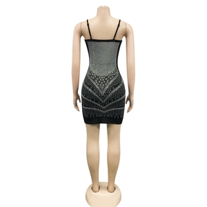 Detail of silver rhinestone geometric patterns on the back of a black bodycon dress