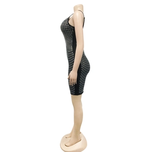 Detail of black bodycon dress with silver rhinestones and thin spaghetti straps
