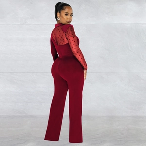 Detail showing the sheer red polka dot mesh back and long sleeves of the elegant jumpsuit