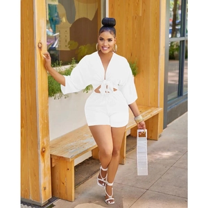 Close-up of white two-piece set featuring V-neck tie crop top and high waist shorts