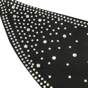 Detail view of sparkling rhinestones on black fabric for a sexy nightclub jumpsuit