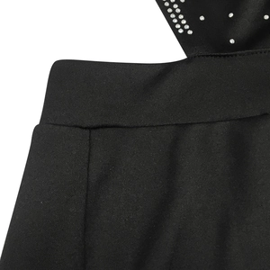 Detail of black fabric with dense silver rhinestones and high-quality craftsmanship