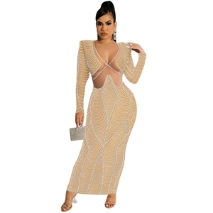 Detail of sheer mesh dress featuring white pearls, rhinestone wave pattern and waist cut-out