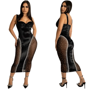 Detail of sheer mesh panels and sparkling silver rhinestones on a black satin bodycon dress