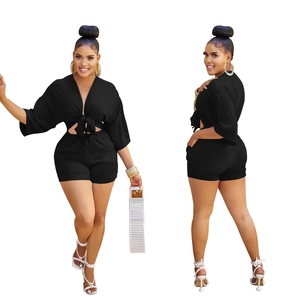 Front and side view of black two-piece set featuring a tie-front crop top and high-waist shorts
