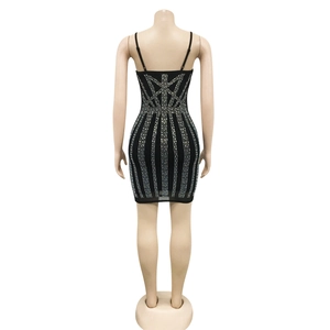Detailed back view of a black mini dress featuring shimmering silver rhinestone patterns