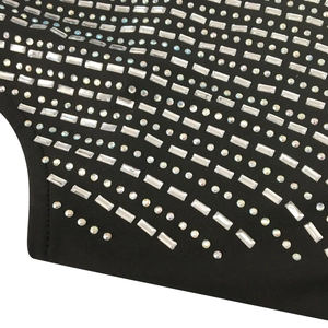 Close-up of sparkling rhinestone patterns on black fabric for a sexy party dress