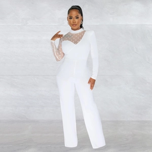 Detail of white jumpsuit showing sheer mesh sleeve with polka dot pattern and sleek fabric