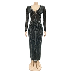 Close-up of black long-sleeve evening dress with silver rhinestones and mesh V-neck