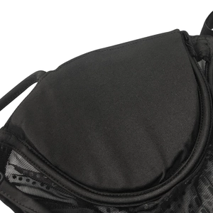 Detail of black mesh lace fabric with polka dots and fine stitching on a sexy dress
