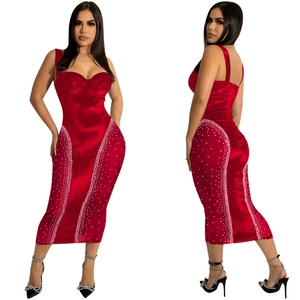 Detail view of red bodycon dress with spaghetti straps and white rhinestone embellishments
