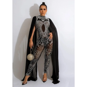 Detail of sheer mesh jumpsuit with silver rhinestones and elegant shoulder cape