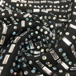 Macro detail of black knitted fabric with luxury rhinestones and crystal embellishments
