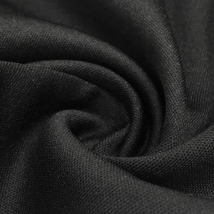 Macro shot of black mesh fabric showing detailed breathable knitted texture and layers