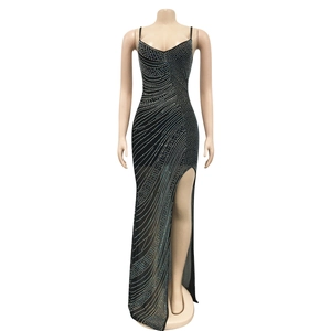 Close-up of sparkling silver rhinestones on a black mesh dress with side slit detail