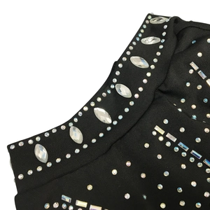 Detail of shimmering silver rhinestones on black mesh fabric for sexy cocktail dress