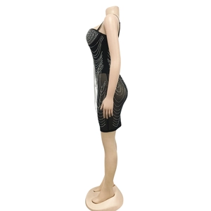 Detailed view of sexy black bodycon dress with sparkling silver rhinestone chain fringe